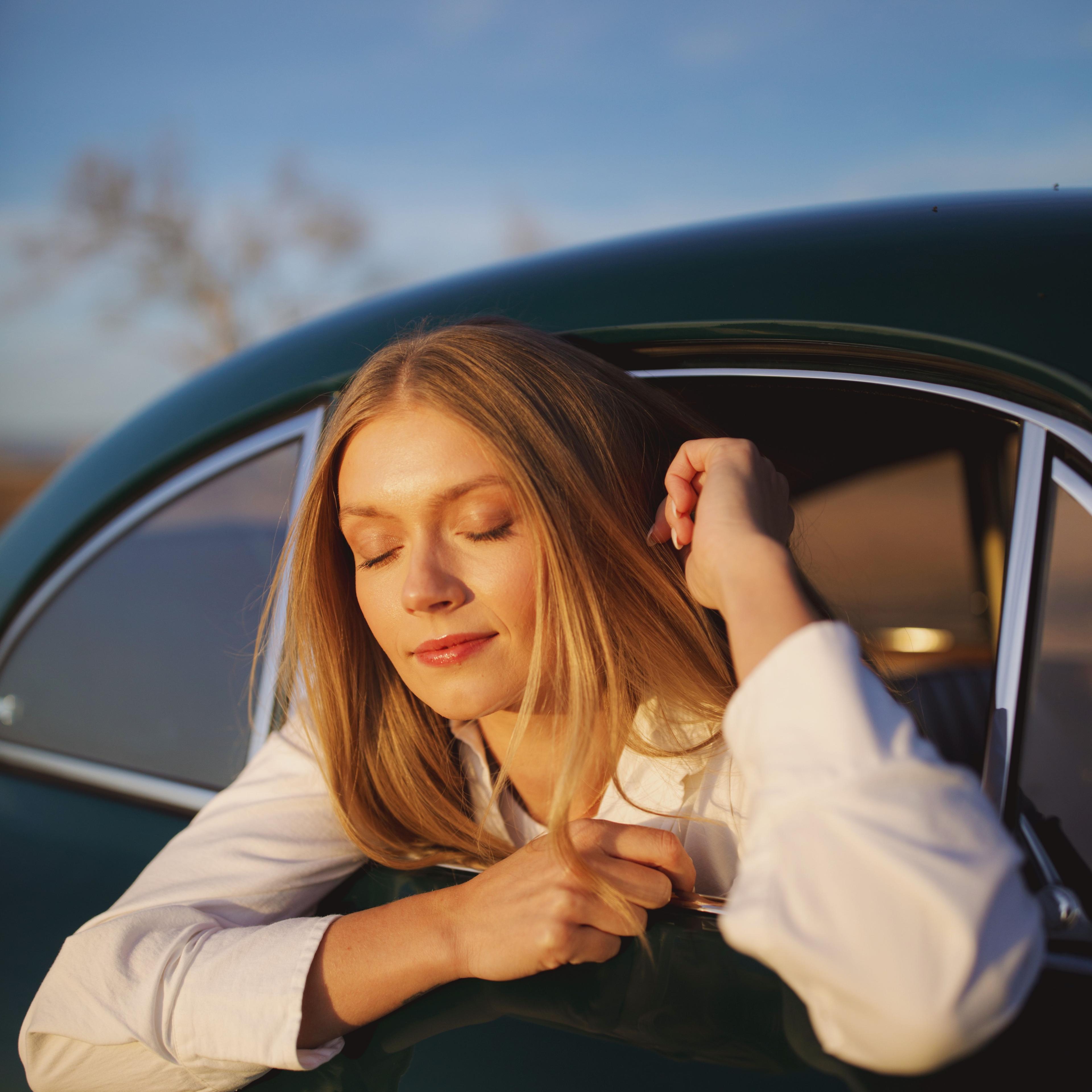 KJ in a vintage car at sunset shot by Natalie Carrasco.