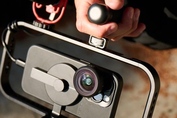 iPhone 16 with attachable mobile lenses on the filmmaker cage.